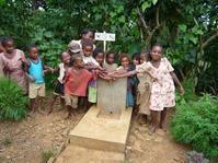 Enfants posant devant la nouvelle borne-fontaine; notez le petit panneau d'information
